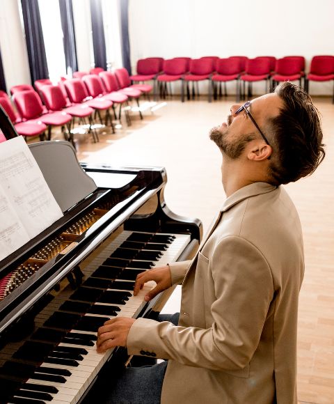 a man playing piano during private lessons